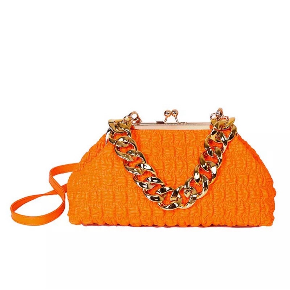 Large size women's handbag with gold chunky chain handle.